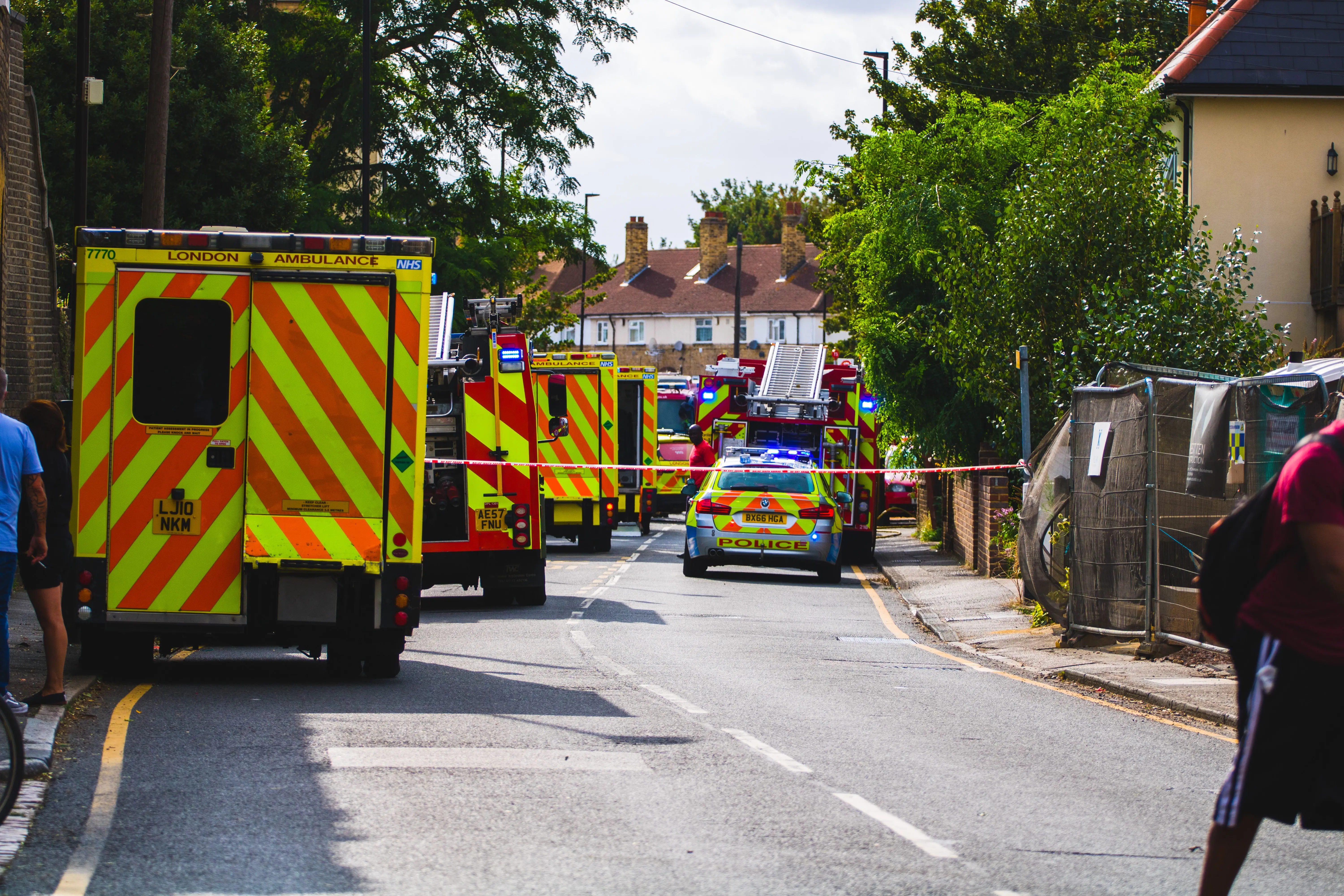 Emergency services vehicles at an incident in the UK including ambulance, fire engine and police car